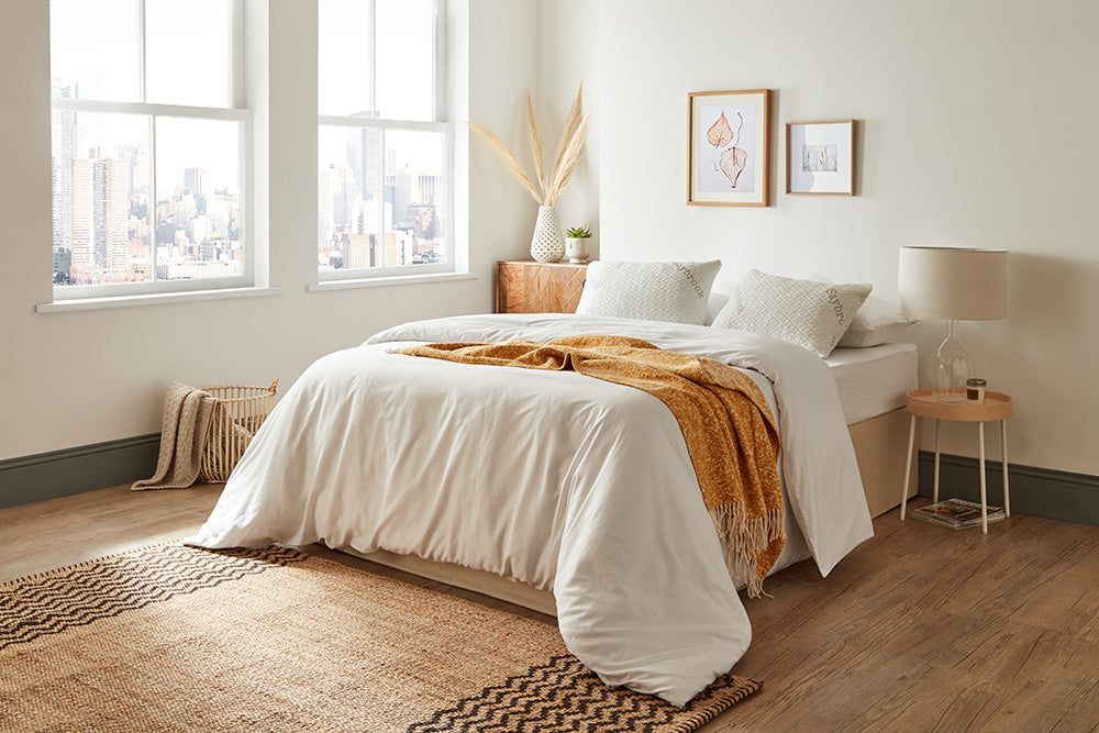 Saybrook pillows on a bed in urban apartment